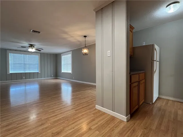 a utility room with wooden floor washer and dryer