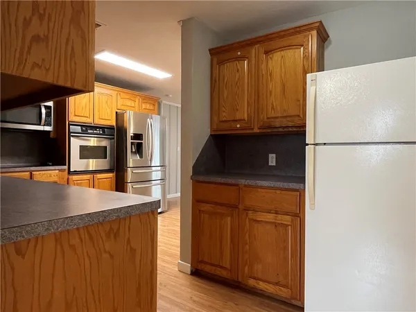 a kitchen with stainless steel appliances a refrigerator and a stove