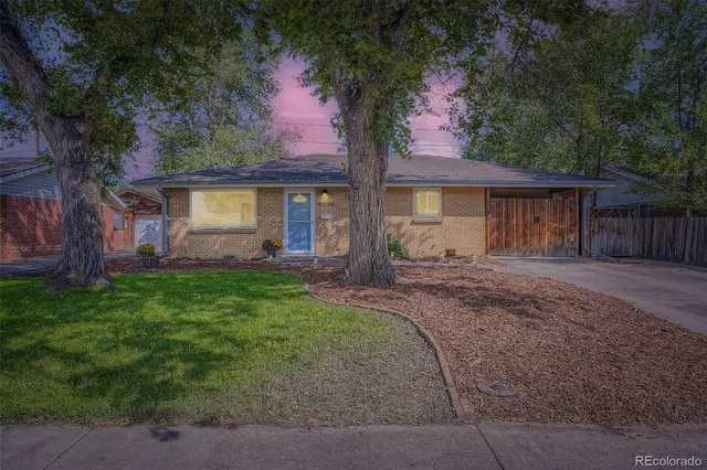 front view of house with a yard and potted plants