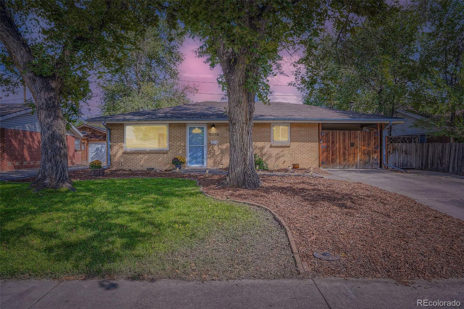 4720 Carr Street Wheat Ridge, CO 80033 - Photo 1 of 31 front view of house with a yard and potted plants