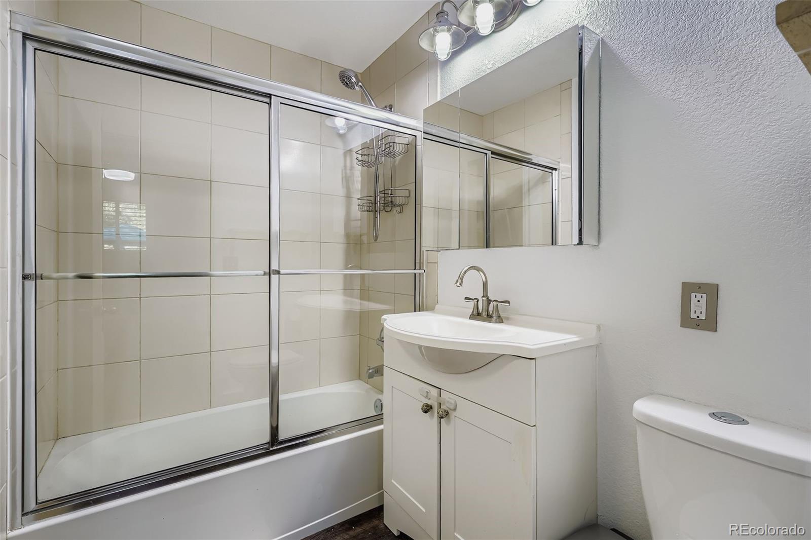 4720 Carr Street Wheat Ridge, CO 80033 - Photo 11 of 31 a bathroom with a sink toilet and shower