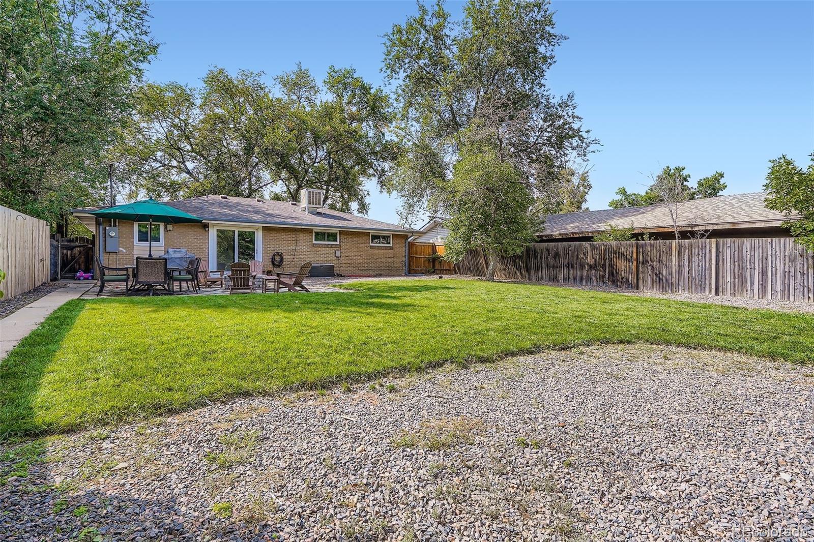 4720 Carr Street Wheat Ridge, CO 80033 - Photo 20 of 31 a view of house with a big yard and large trees
