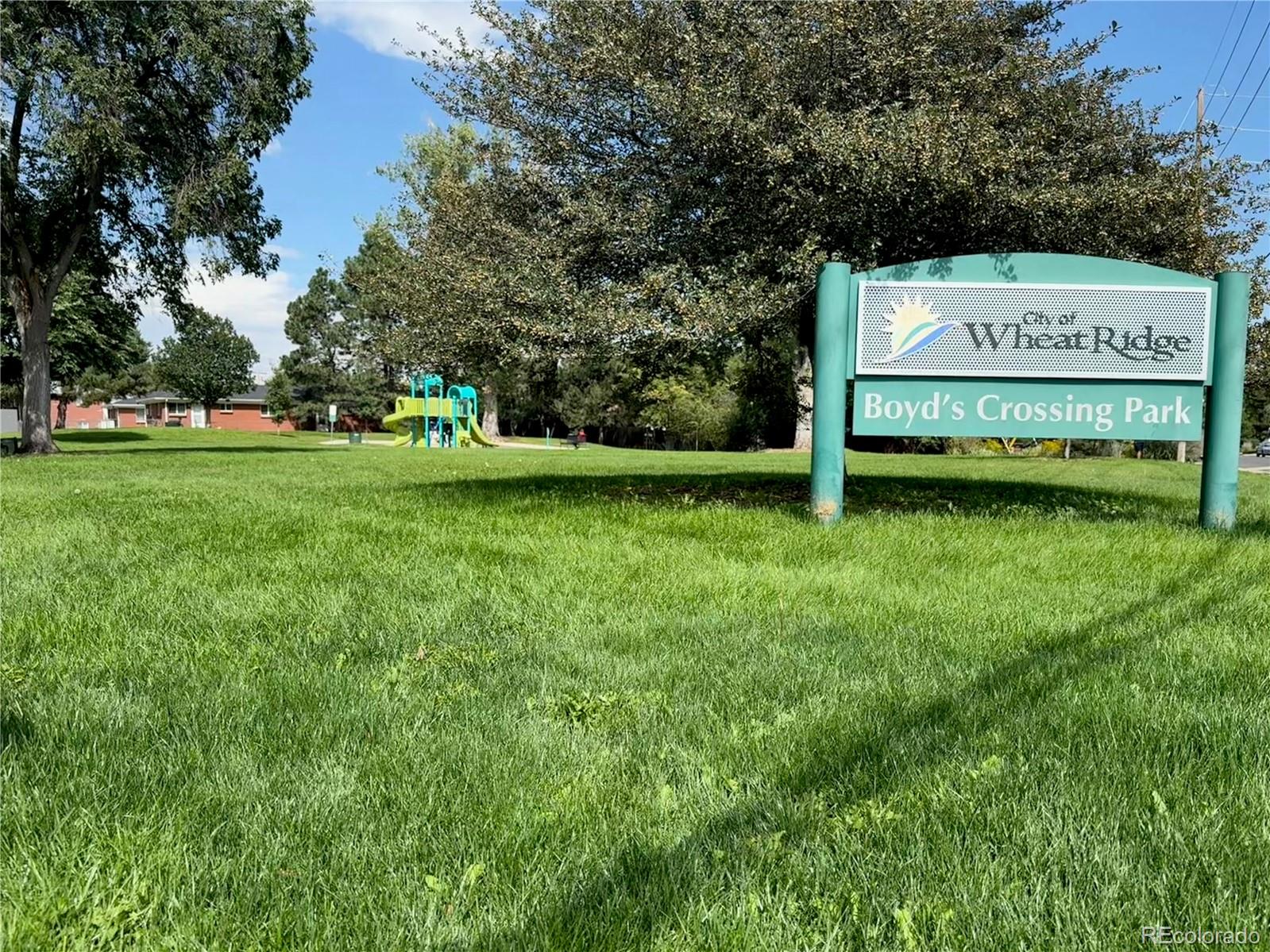 4720 Carr Street Wheat Ridge, CO 80033 - Photo 24 of 31 a sign on the side of the grass and trees
