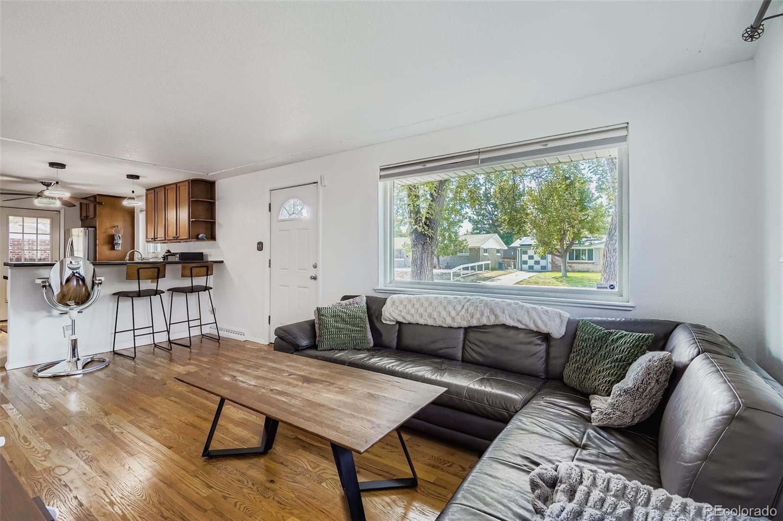 4720 Carr Street Wheat Ridge, CO 80033 - Photo 3 of 31 a living room with furniture and a large window
