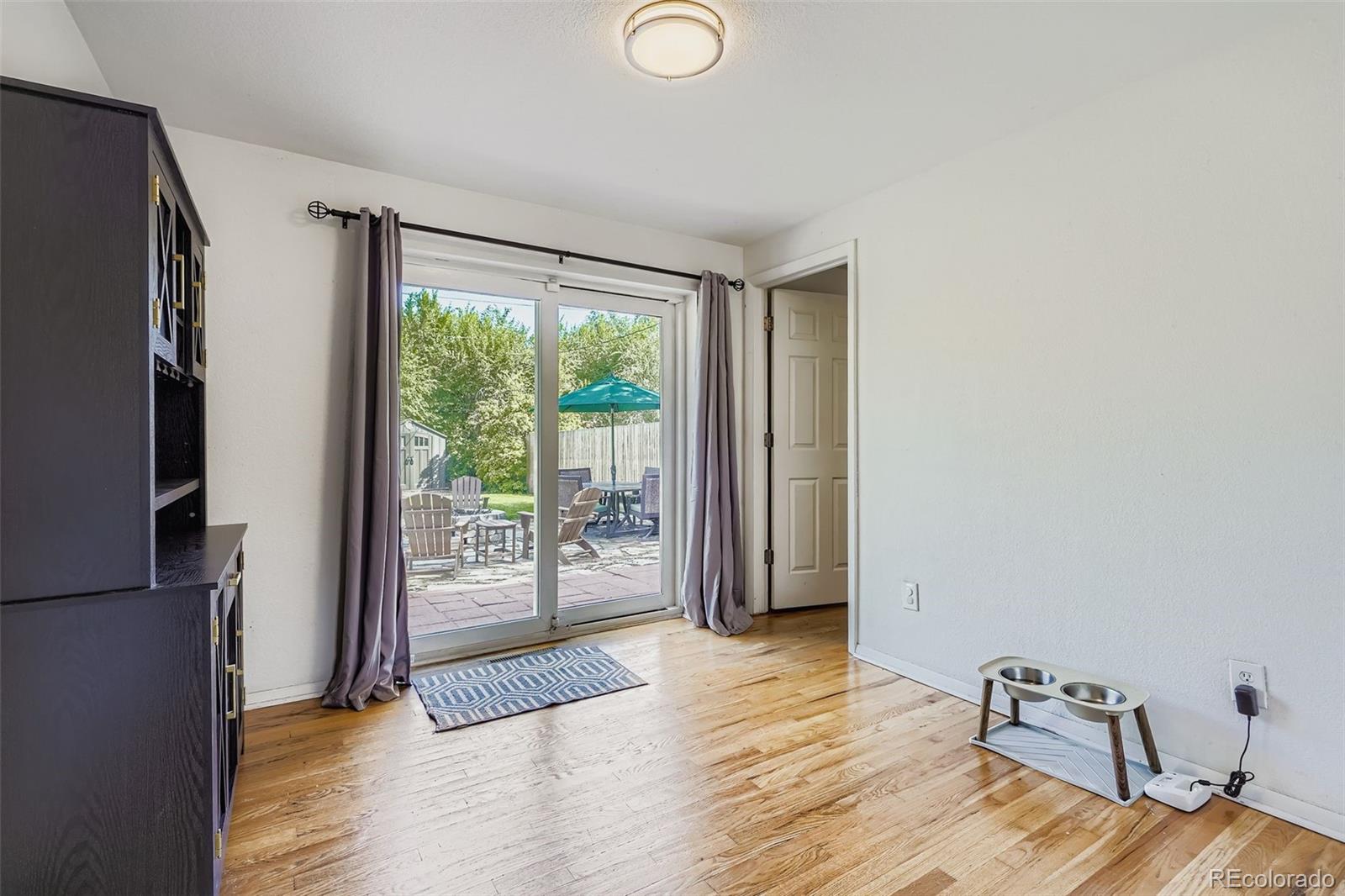 4720 Carr Street Wheat Ridge, CO 80033 - Photo 8 of 31 a view of an empty room with wooden floor and a window