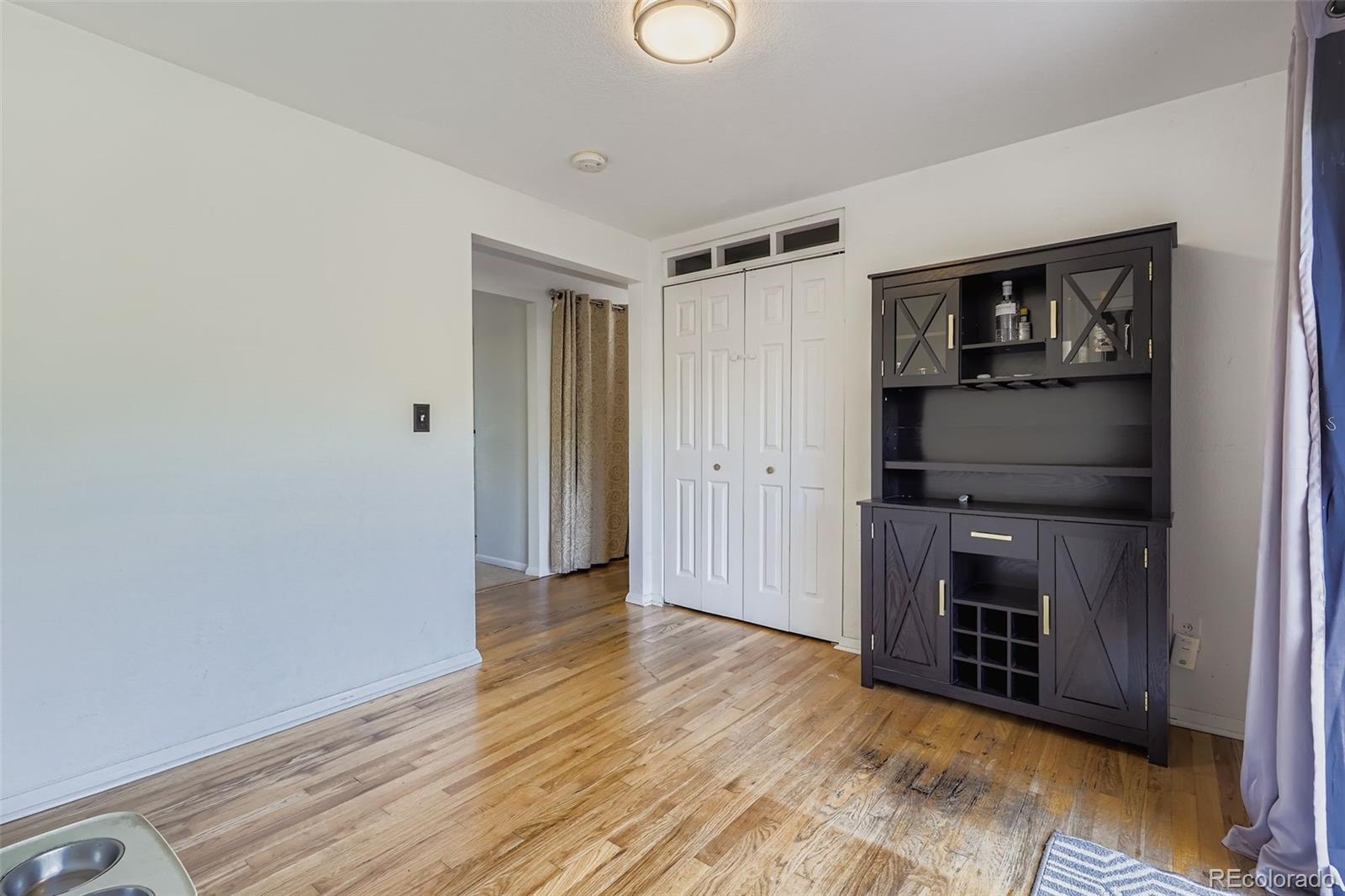 4720 Carr Street Wheat Ridge, CO 80033 - Photo 9 of 31 a view of an empty room with wooden floor and a window