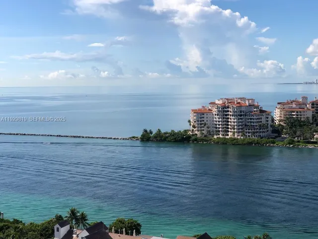 a view of a ocean with tall buildings