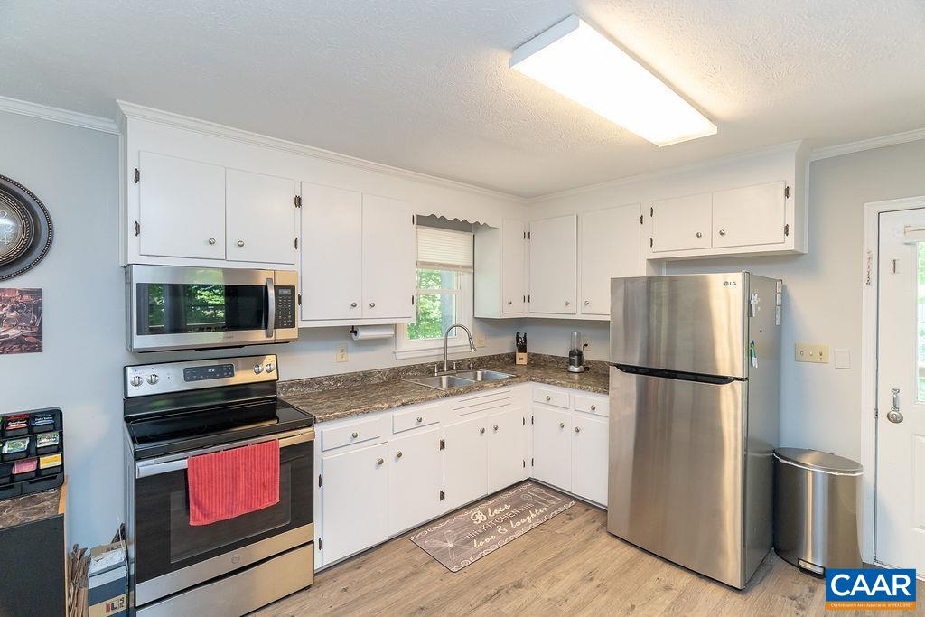 6920 Albevanna Spring Road Scottsville, VA 24590 - Photo 11 of 47 a kitchen with a refrigerator stove and sink