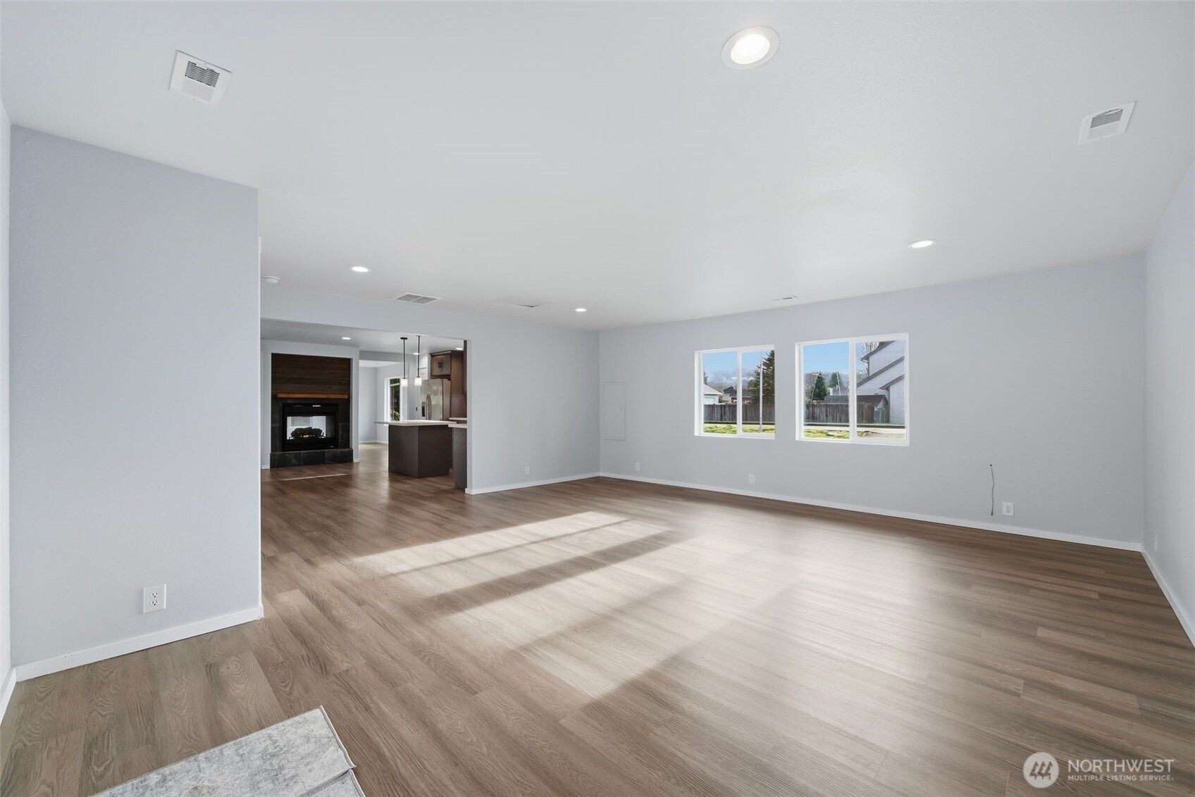 731 High Avenue Sultan, WA 98294 - Photo 3 of 37 an empty room with wooden floor kitchen view and windows