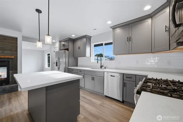 a kitchen with a sink stove and cabinets