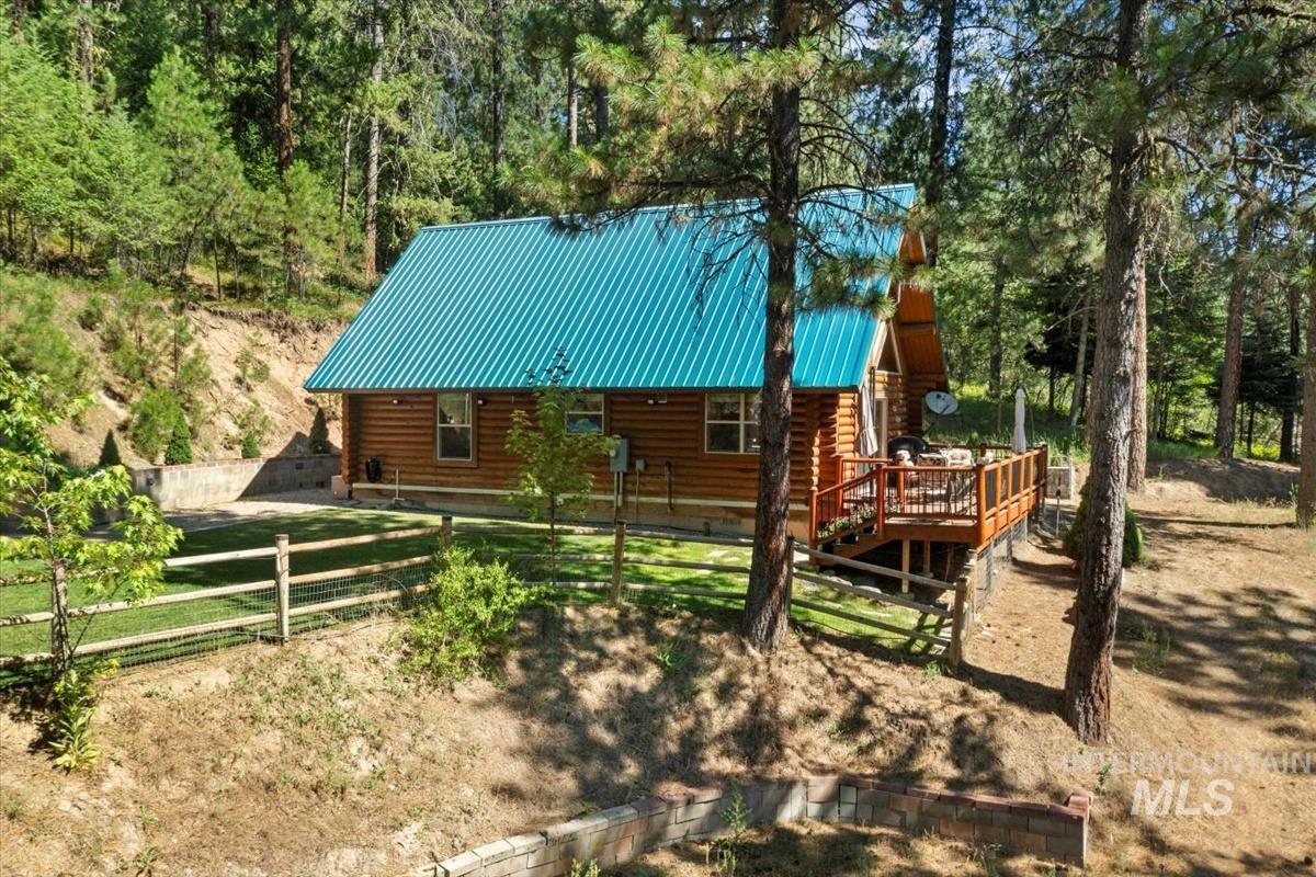 10 Elk Point Road Garden Valley, ID 83622 - Photo 3 of 42 View of front of property with log exterior, a metal roof, and a deck