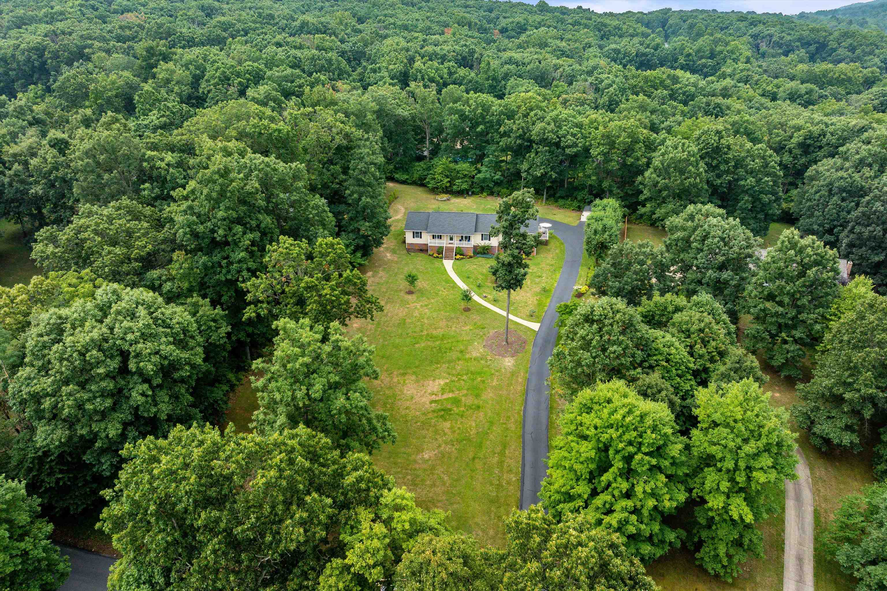 an aerial view of a house with a yard