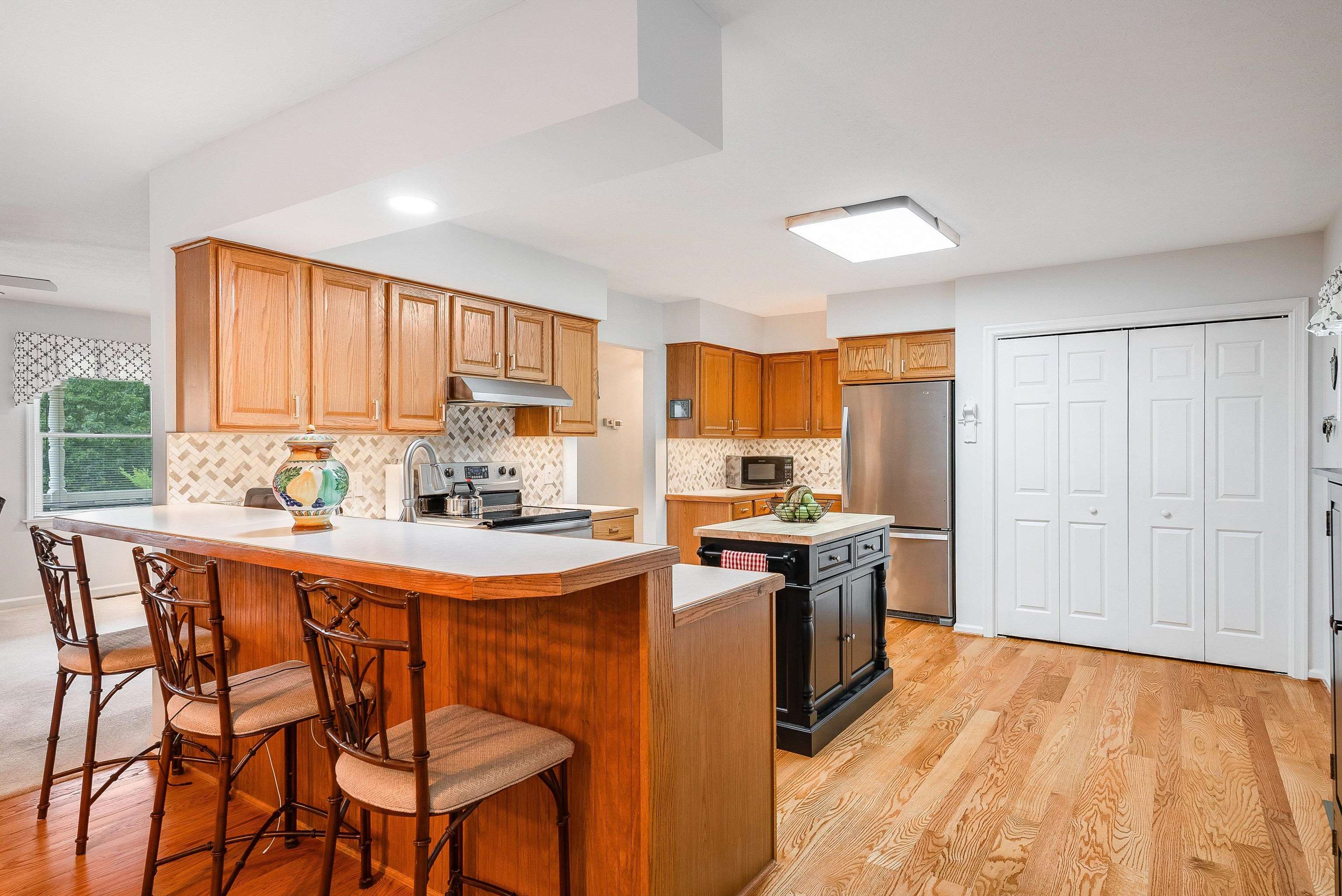 31 Folly Mills Station Road Staunton, VA 24401 - Photo 16 of 48 a kitchen with stainless steel appliances granite countertop a stove a sink dishwasher and a refrigerator with wooden floor