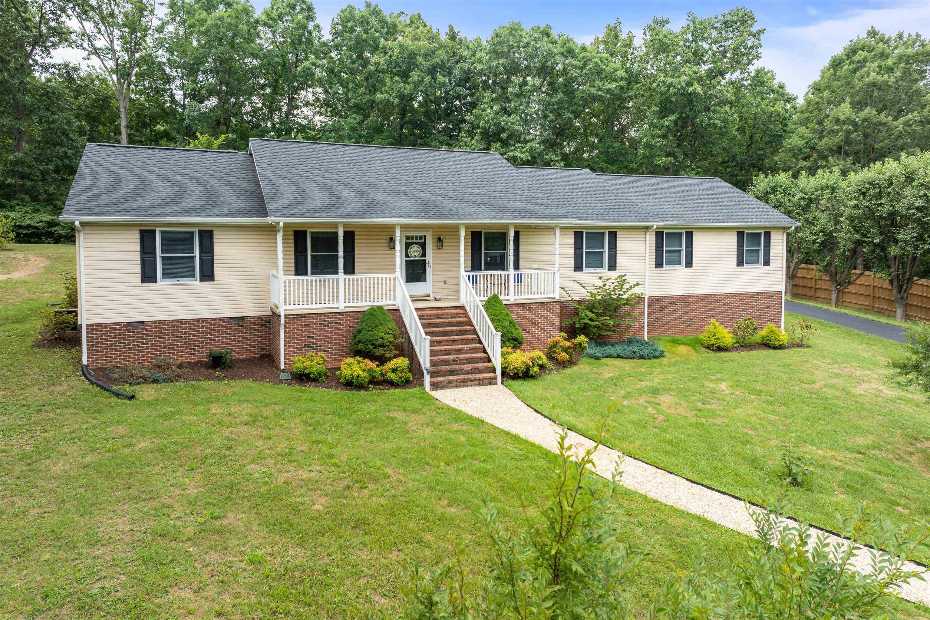 31 Folly Mills Station Road Staunton, VA 24401 - Photo 3 of 48 a view of a yard in front of a house with plants and large tree
