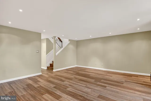 a view of a livingroom with wooden floor and a fireplace