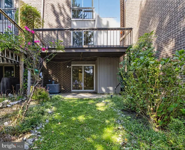 a front view of a house with plants