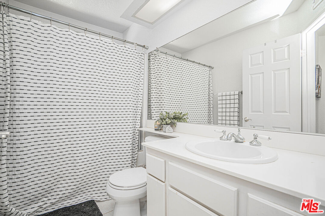20807 Canyon Ridge Road Diamond Bar, CA 91789 - Photo 11 of 16 a bathroom with a sink a toilet and mirror