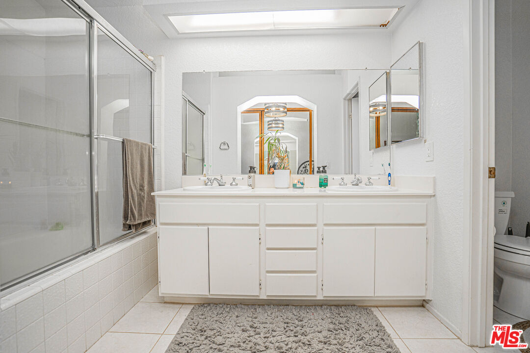 20807 Canyon Ridge Road Diamond Bar, CA 91789 - Photo 13 of 16 a bathroom with a sink a mirror and a shower