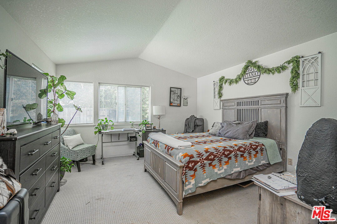 20807 Canyon Ridge Road Diamond Bar, CA 91789 - Photo 14 of 16 a bedroom with a bed and a chandelier