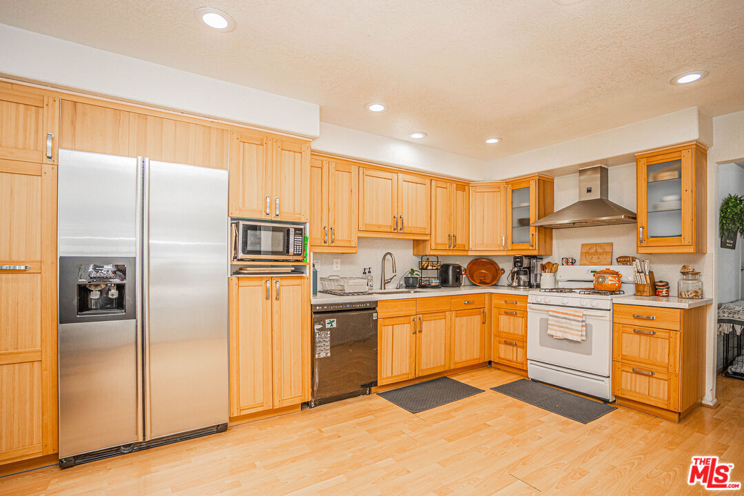 20807 Canyon Ridge Road Diamond Bar, CA 91789 - Photo 4 of 16 a kitchen with stainless steel appliances granite countertop a refrigerator and a stove top oven