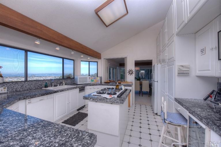 16 Pearce Road San Rafael, CA 94901 - Photo 1 of 1 a kitchen with stainless steel appliances kitchen island granite countertop a sink stove and cabinets