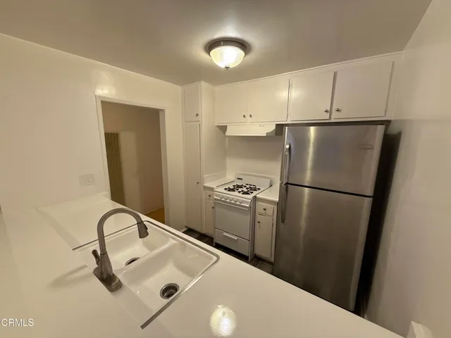 a kitchen with stainless steel appliances a refrigerator and a sink