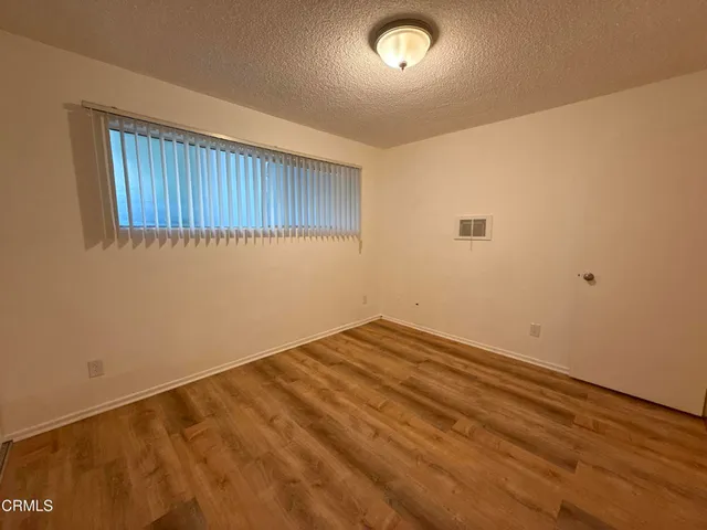 an empty room with wooden floor