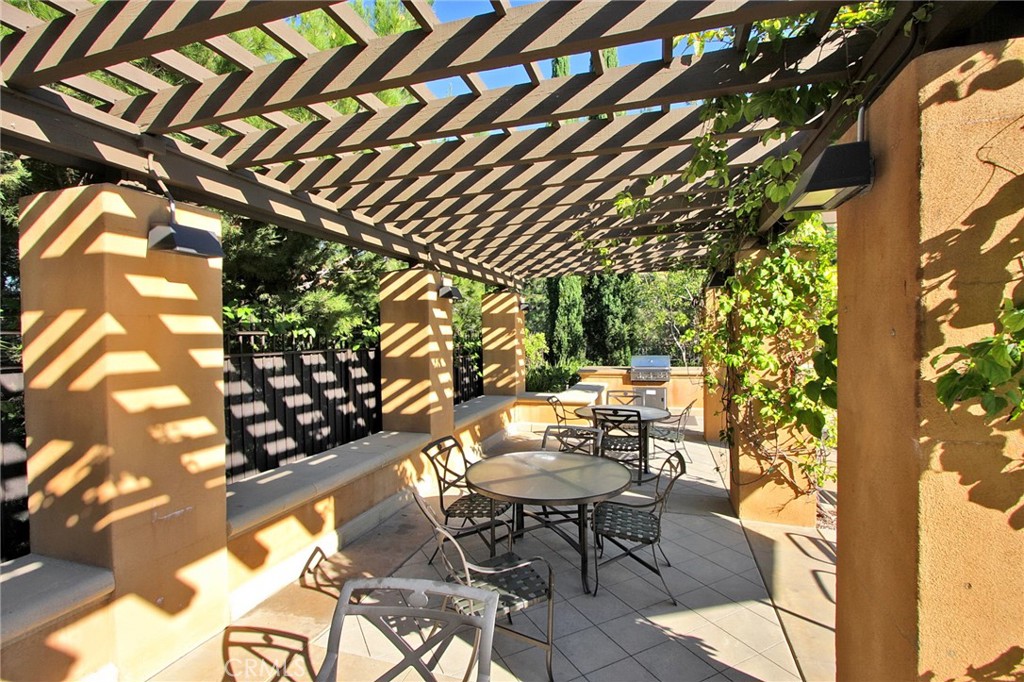 237 Coral Rose Irvine, CA 92603 - Photo 4 of 6 a backyard of a house with table and chairs