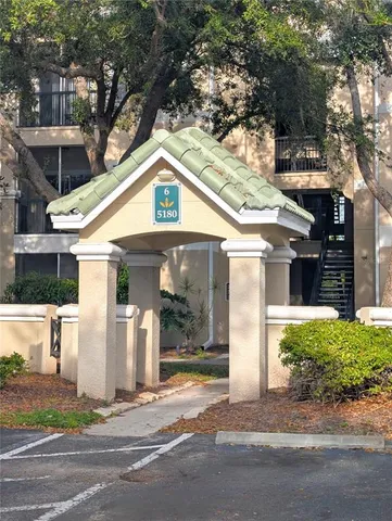 a front view of a house with a yard garage and outdoor seating
