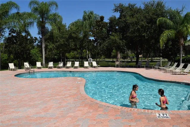 a view of a swimming pool with a patio