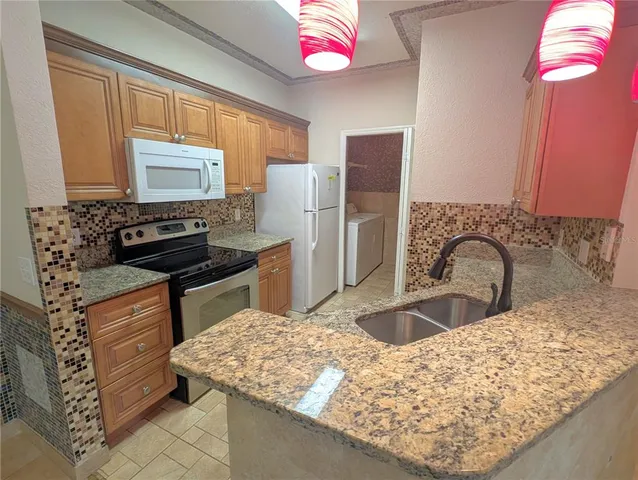 a very nice looking dining room with a fireplace and a chandelier