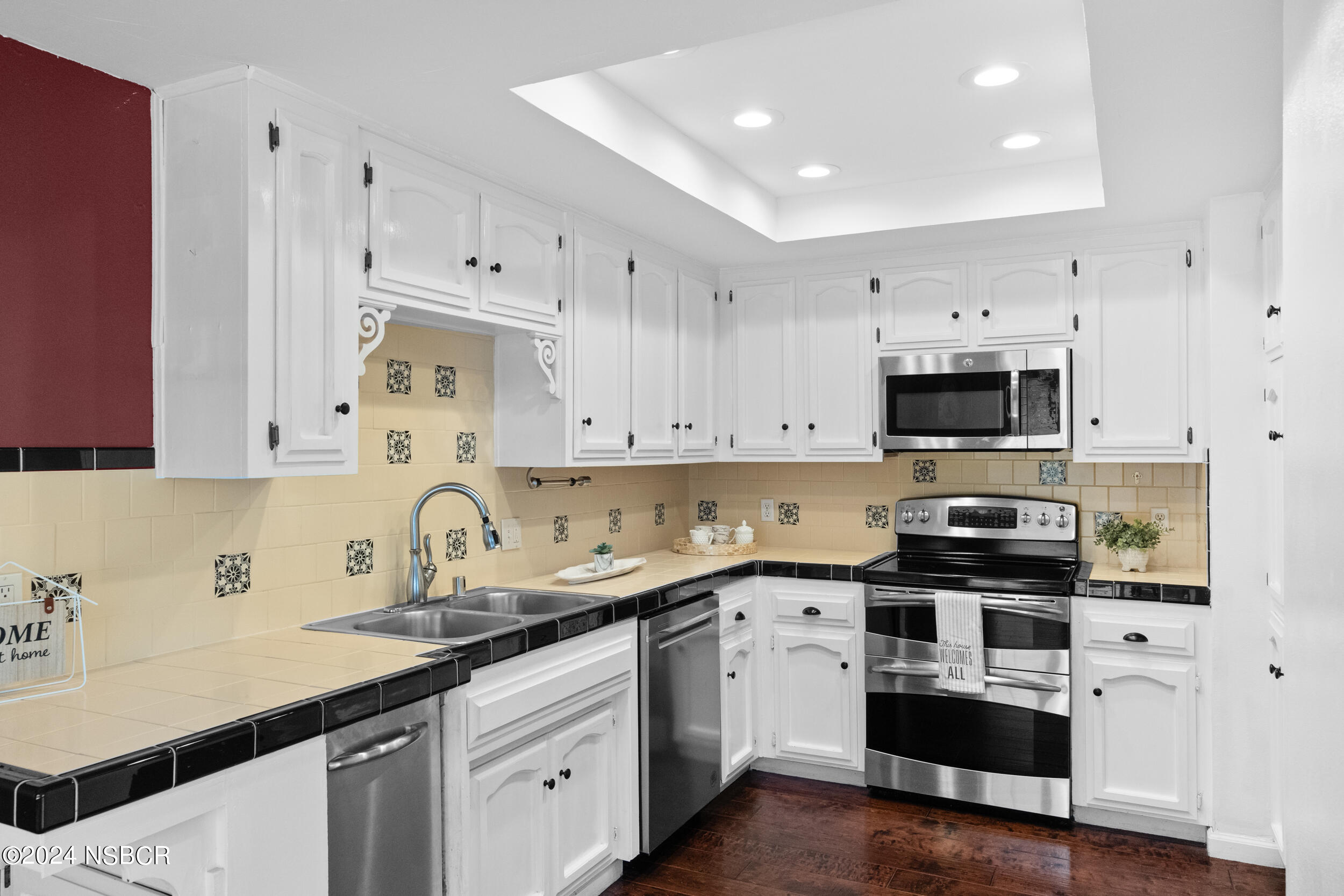 1113 James Way Arroyo Grande, CA 93420 - Photo 12 of 30 a kitchen with cabinets stainless steel appliances a sink and wooden floor