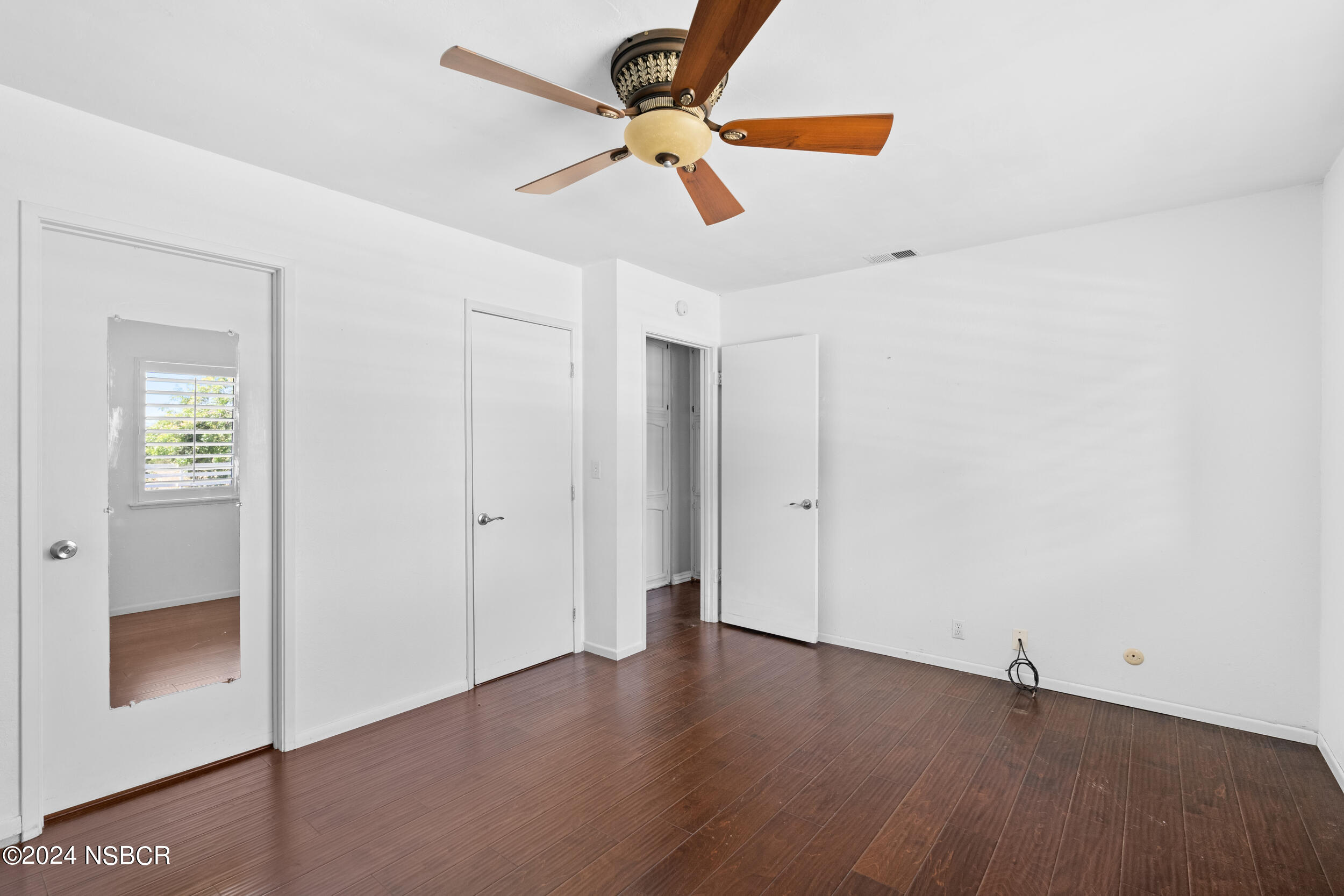 1113 James Way Arroyo Grande, CA 93420 - Photo 17 of 30 a view of an empty room with window and wooden floor