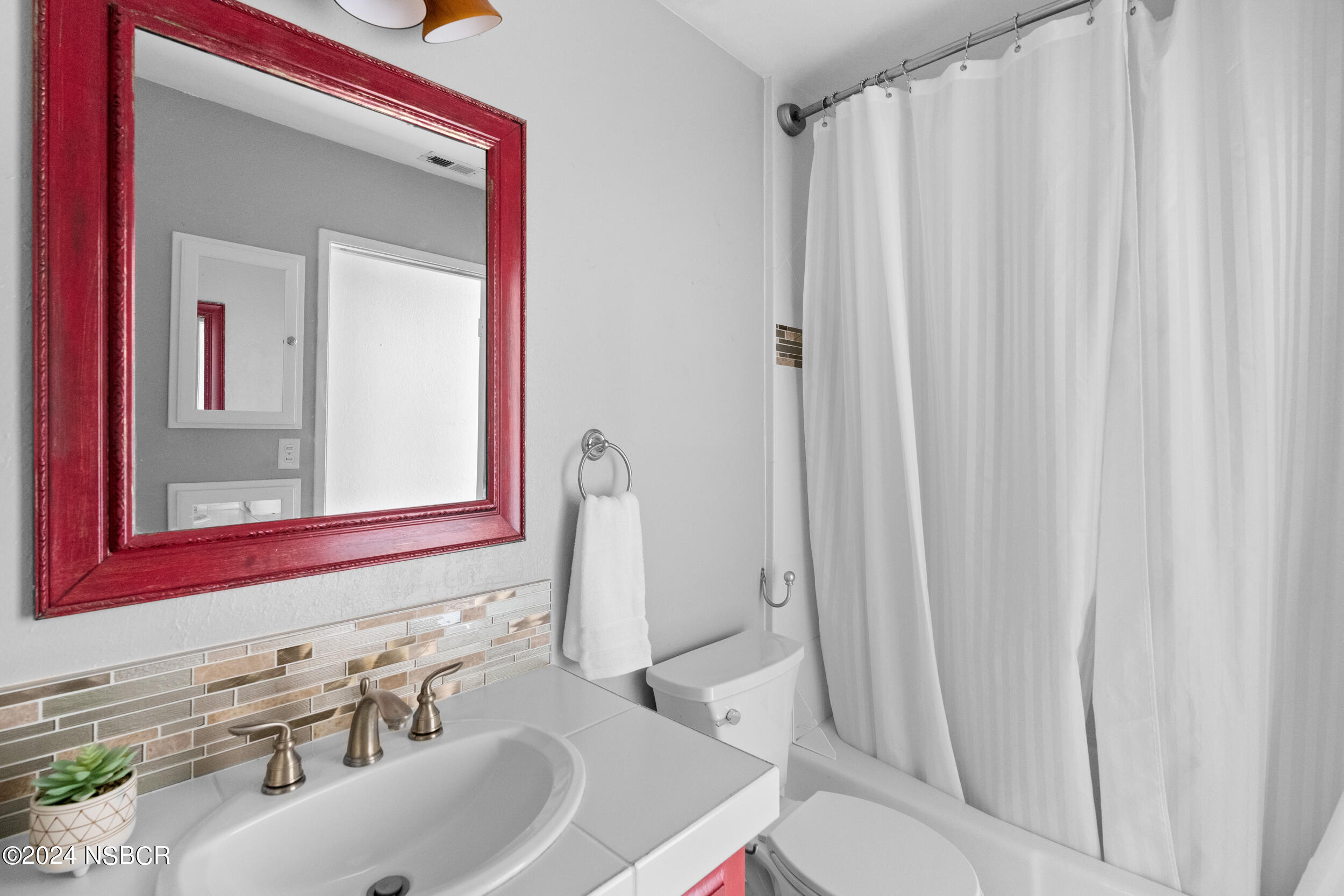 1113 James Way Arroyo Grande, CA 93420 - Photo 19 of 30 a bathroom with a sink a toilet and a mirror