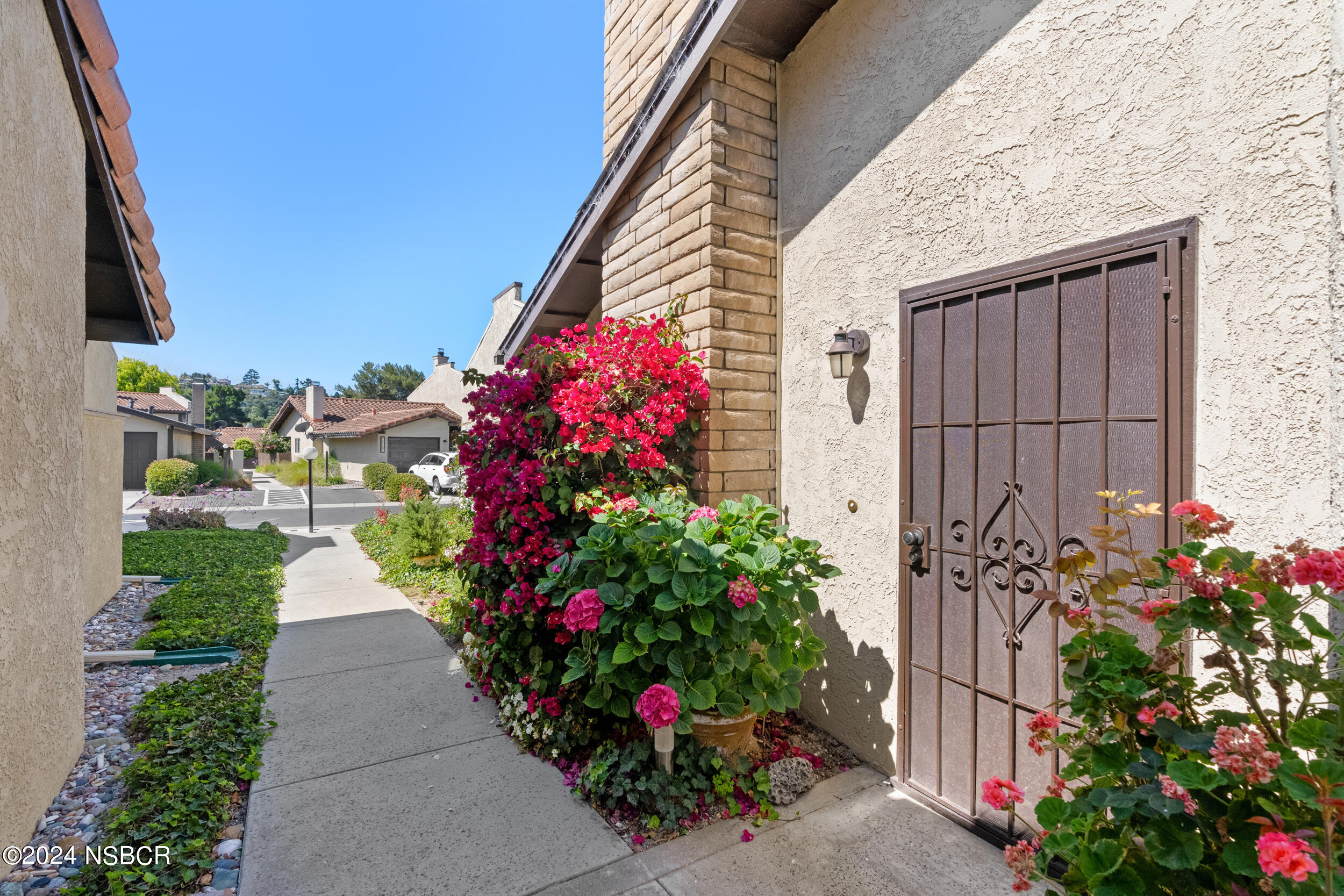 1113 James Way Arroyo Grande, CA 93420 - Photo 2 of 30 a view of a potted flower in a yard with a fountain