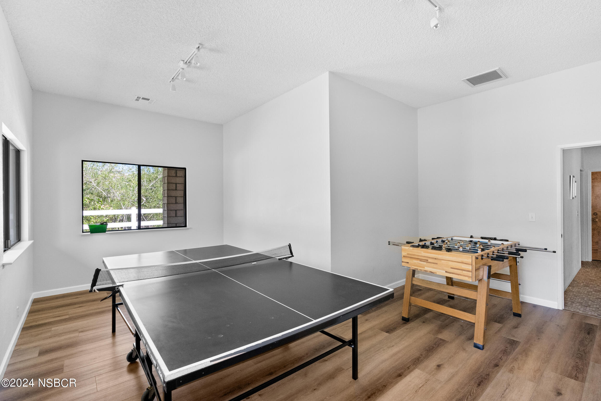 1113 James Way Arroyo Grande, CA 93420 - Photo 27 of 30 a sitting area with wooden floor and windows