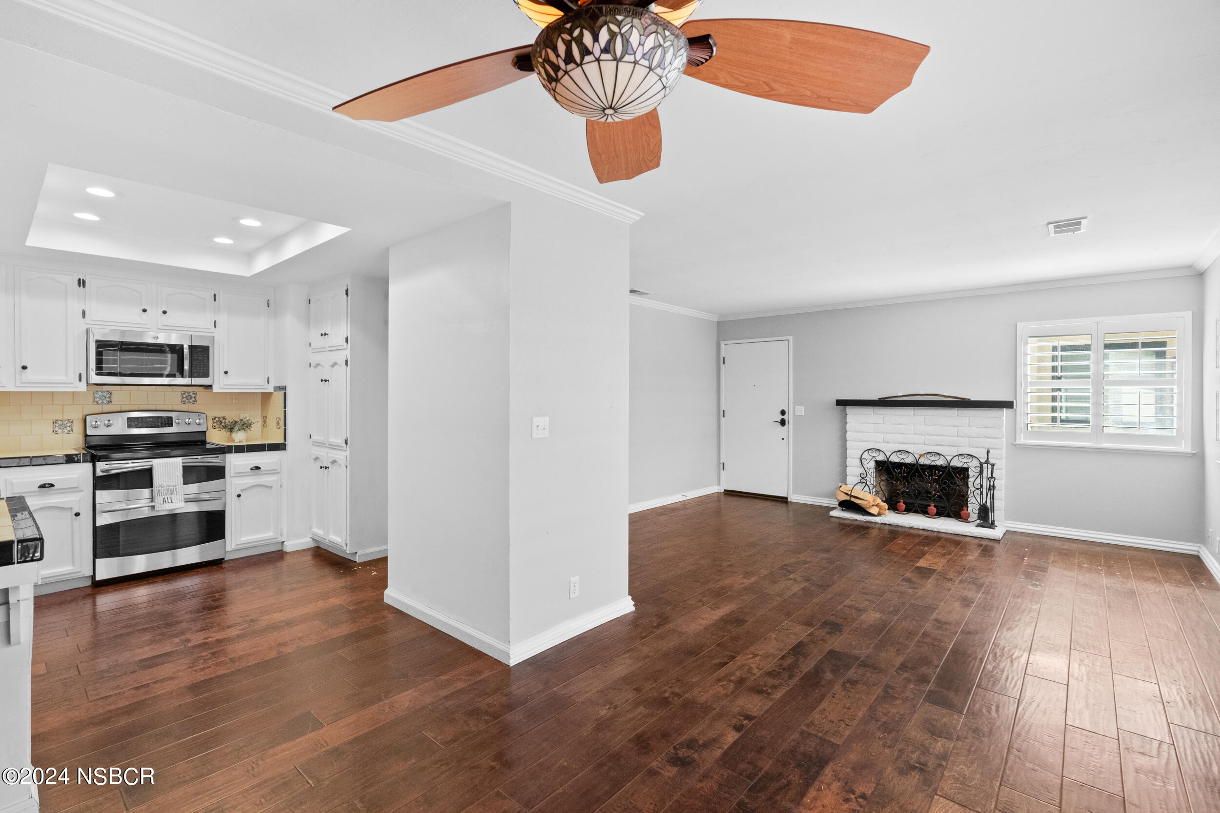 1113 James Way Arroyo Grande, CA 93420 - Photo 4 of 30 a view of kitchen and empty room with wooden floor