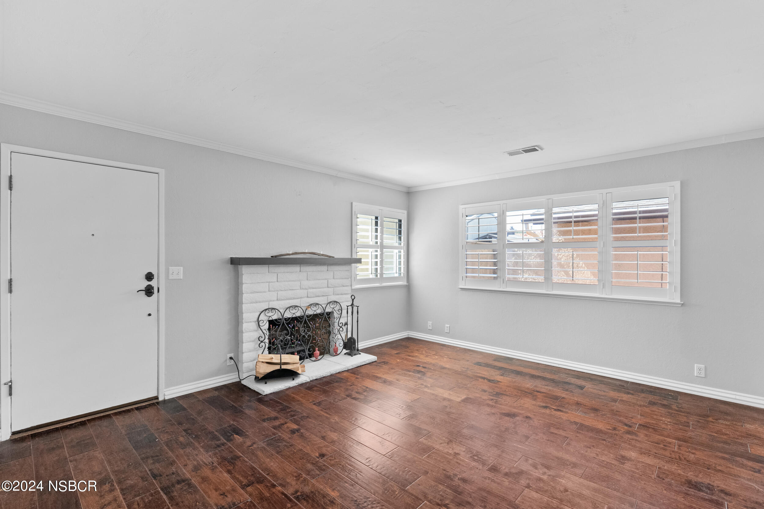 1113 James Way Arroyo Grande, CA 93420 - Photo 6 of 30 a view of an empty room with wooden floor fireplace and a window