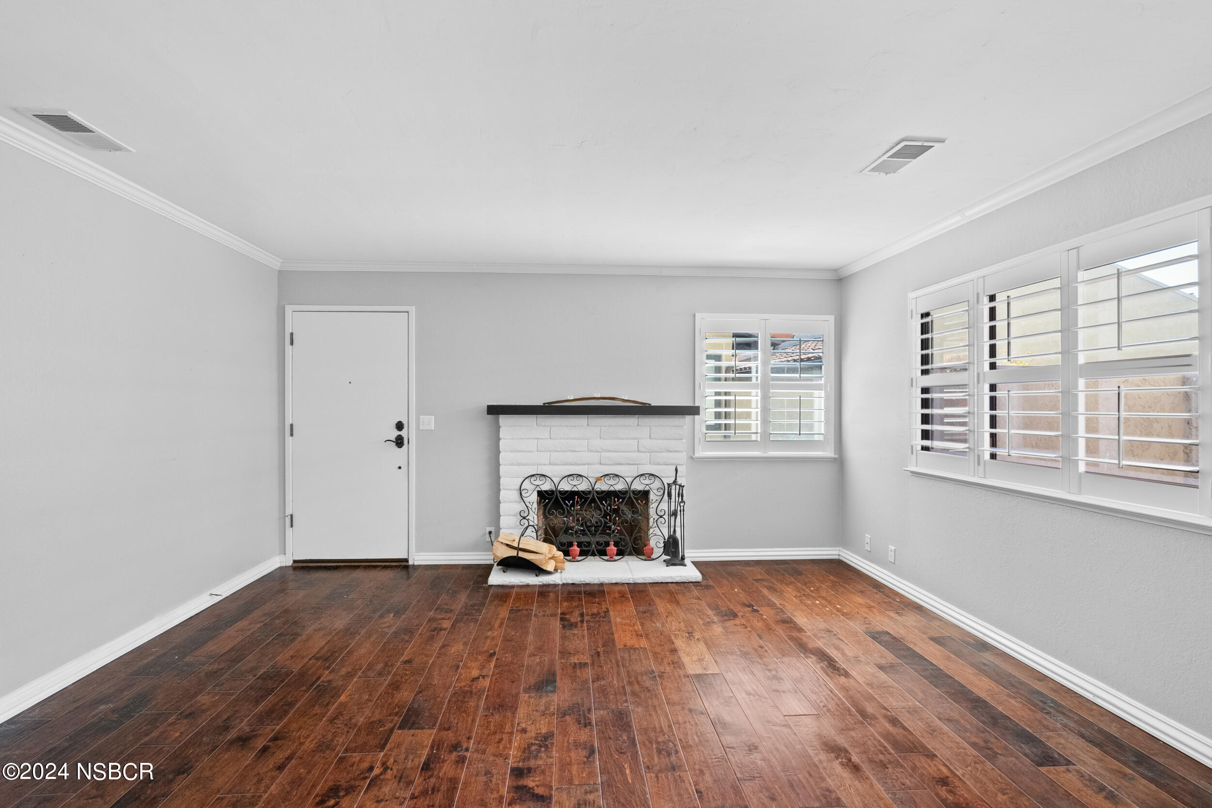 1113 James Way Arroyo Grande, CA 93420 - Photo 7 of 30 an empty room with fireplace wooden floor and windows