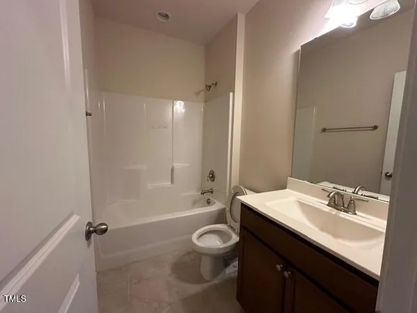 an empty room with wooden floor and a window