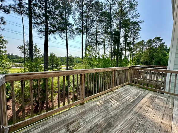 a view of balcony with wooden floor and fence