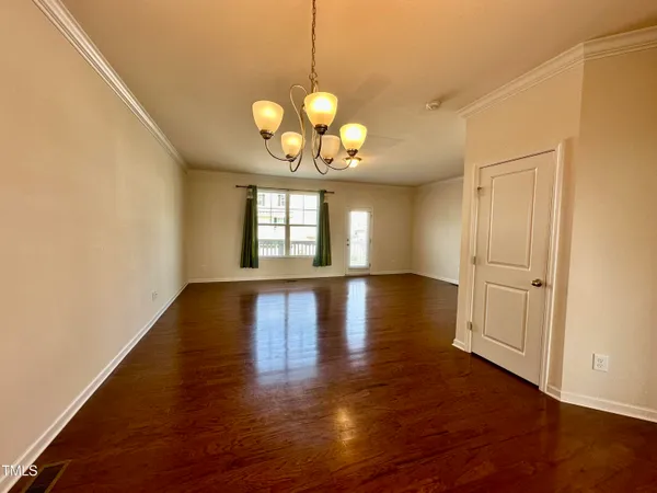 a view of a room with wooden floor