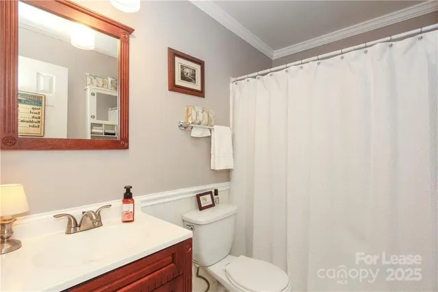 a bathroom with a sink vanity mirror and toilet