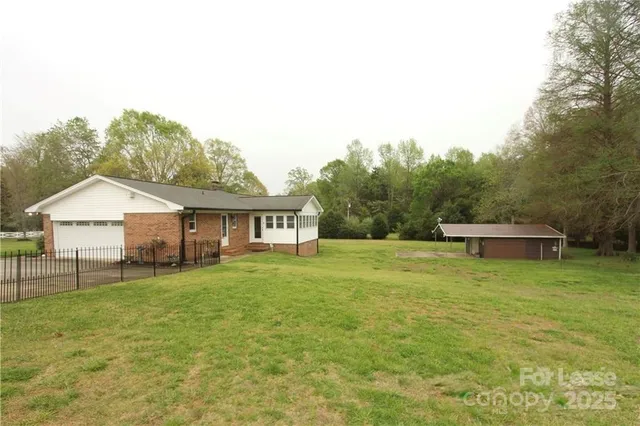 a view of a house with a yard and sitting area