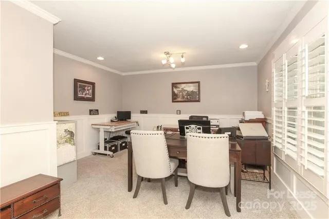a view of a dining room with furniture and a window