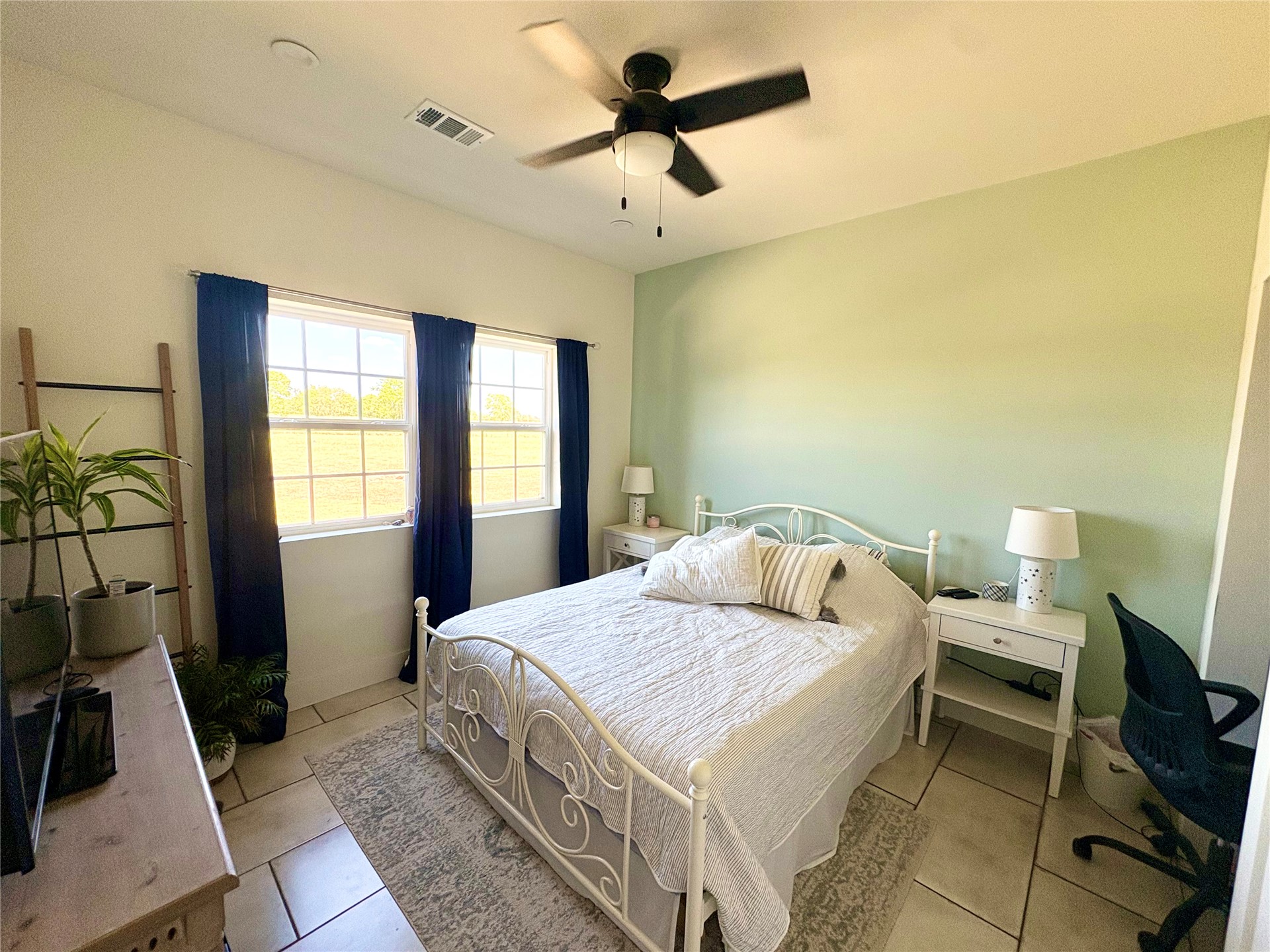 313 Nauvoo Hills Road Caddo, OK 74729 - Photo 24 of 41 Recessed lighting, ceiling fan, two windows with gridded panes, light green accent wall, and tiled flooring