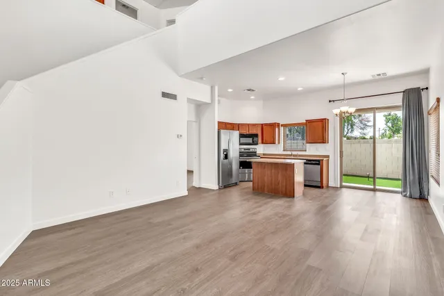 a kitchen with kitchen island granite countertop a stove a sink and a refrigerator