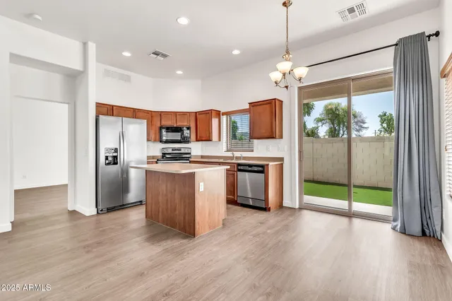 a kitchen with stainless steel appliances granite countertop a refrigerator stove and microwave