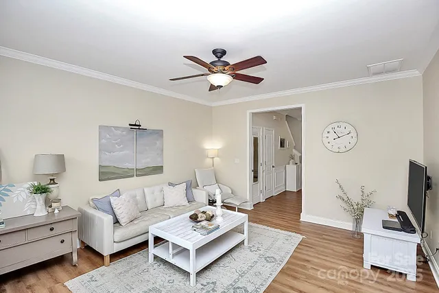 a living room with furniture a rug and a flat screen tv