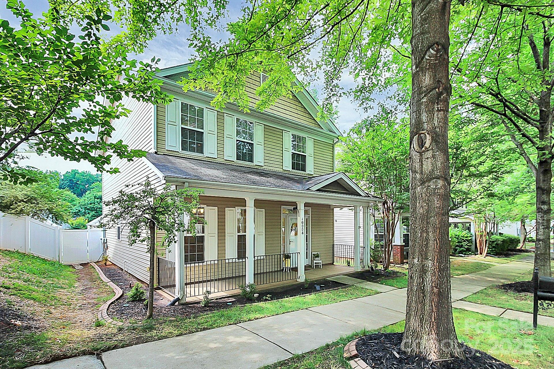 10008 Caldwell Depot Road Cornelius, NC 28031 - Photo 2 of 33 a front view of a house with a yard table and chairs